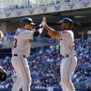 Cleveland Indians' Michael Bourn, right, welcomes Nick Swisher, left, at home plate after they both scored on Swisher's 2 RBI home run off Minnesota Twins starting pitcher Scott Diamond (58) during the first inning of an MLB American League baseball game in Minneapolis, Sunday, Sept. 29, 2013. (AP Photo/Ann Heisenfelt)