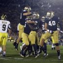 Notre Dame's Nicky Baratti, second from right, is congratulated by teammates after intercepting a pass intended for Michigan's Drew Dileo (9) during the first half of an NCAA college football game Saturday, Sept. 22, 2012, in South Bend, Ind. (AP Photo/Darron Cummings)