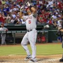 Los Angeles Angels first baseman Albert Pujols (5) points to the sky, as he touches the plate, after hitting his second home run of the game, in the sixth inning of a baseball game against the Texas Rangers on Tuesday, July 31, 2012, in Arlington, Texas.  (AP Photo/John F. Rhodes)
