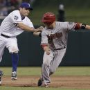 Arizona Diamondbacks Aaron Hill, right, is tagged out by Texas Rangers second baseman Ian Kinsler between first and second bases during the sixth inning of a baseball game, Tuesday, June 12, 2012, in Arlington, Texas. (AP Photo/LM Otero)