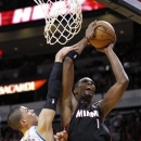 Miami Heat forward Chris Bosh goes up for a shot against New Orleans Hornets guard Austin Rivers (25) during the first quarter of a preseason NBA basketball game, Friday, Oct. 26, 2012 in Miami. AP Photo/Wilfredo Lee)