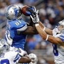 Detroit Lions wide receiver Calvin Johnson (81) pulls in a 54-yard reception as Dallas Cowboys cornerback Brandon Carr (39) and Dallas Cowboys defensive back Jeff Heath (38) defends in the fourth quarter of an NFL football game in Detroit, Sunday, Oct. 27, 2013. (AP Photo/Duane Burleson)