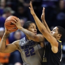 Kansas State guard Rodney McGruder (22) is covered by West Virginia guard Gary Browne (14) during the first half of an NCAA college basketball game in Manhattan, Kan., Monday, Feb. 18, 2013. (AP Photo/Orlin Wagner)