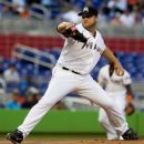 Miami Marlins' Mark Buehrie throws to the Chicago Cubs during the first inning of abaseball game in Miami, Wednesday, April 18, 2012. (AP Photo/J Pat Carter)
