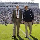 File - In this Oct. 8, 2011, file photo Penn State president Graham Spanier, left, and head football coach Joe Paterno chat before an NCAA college football game against Iowa in State College, Pa. As Penn State tries to move past the scandal after Sandusky's trial, the devastating Freeh Report and unprecedented NCAA penalties, Title IX remains a potential long-term legal problem. The reason: Not only have Title IX lawsuits produced some of the most expensive judgments against universities in recent years, but the law allows for the possibility, however unlikely, that a university's access to all federal dollars could be cut off. (AP Photo/Gene Puskar, File)