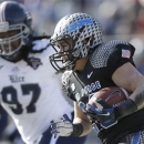 Air Force running back Cody Getz (28) runs against Rice defensive end Jared Williams (97) during the first half of the Armed Forces Bowl NCAA college football game Saturday, Dec. 29, 2012, in Fort Worth, Texas. (AP Photo/LM Otero)
