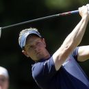 Luke Donald, of England, tees off on the ninth hole during the final round of play in the Tour Championship golf tournament in Atlanta, Sunday, Sept. 23, 2012. (AP Photo/John Bazemore)