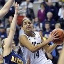 Connecticut's Bria Hartley, right, drives past Marquette's Brooklyn Pumroy during the first half of an NCAA college basketball game in Storrs, Conn., Tuesday, Feb. 5, 2013. (AP Photo/Fred Beckham)