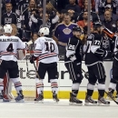 The Chicago Blackhawks celebrate their 3-2 win as the Los Angeles Kings return to the bench in the third period of Game 4 of the NHL hockey Stanley Cup playoffs Western Conference finals, in Los Angeles on Thursday, June 6, 2013. (AP Photo/Reed Saxon)