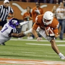 Texas quarterback David Ash, right, is brought down by TCU's Sam Carter (17) during the first half of an NCAA college football game on Thursday, Nov. 22, 2012, in Austin, Texas. (AP Photo/Jack Plunkett)