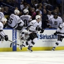 Members of the Los Angeles Kings rush off the bench to congratulate teammate Slava Voynov, of Russia, on his game-winning goal during overtime in Game 5 of a first-round NHL hockey Stanley Cup playoff series against the St. Louis Blues Wednesday, May 8, 2013, in St. Louis. The Kings won 3-2. (AP Photo/Jeff Roberson)