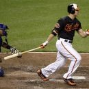 Baltimore Orioles' Chris Davis, right, singles in the fifth inning of a baseball game against the Kansas City Royals in Baltimore, Friday, May 25, 2012. Orioles' Adam Jones scored on the play. Baltimore won 8-2. (AP Photo/Patrick Semansky)
