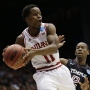 Indiana guard Yogi Ferrell (11) looks to pass around Temple guard Will Cummings (2) in the first half of a third-round game of the NCAA college basketball tournament Sunday March 24, 2013, in Dayton, Ohio. (AP Photo/Al Behrman)