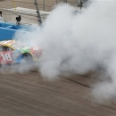 Kyle Busch spins out in Turn 1 during the NASCAR Sprint Cup Series auto race, Sunday, March 3, 2013, in Avondale, Ariz. (AP Photo/Matt York)