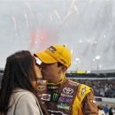 Kyle Busch kisses his wife, Samantha, during opening ceremonies for the NASCAR Sprint Cup Series auto race at Richmond International Raceway in Richmond, Va., Saturday, April 28, 2012. (AP Photo/Zach Gibson)