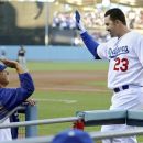 Los Angeles Dodgers' Adrian Gonzalez, right, is congratulated by manager Don Mattingly after hitting a three-run home run during the first inning of the Dodgers' baseball game against the Miami Marlins, Saturday, Aug. 25, 2012, in Los Angeles. (AP Photo/Mark J. Terrill)