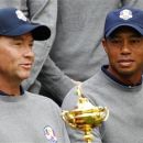 U.S. golfer Tiger Woods (R) looks at the Ryder Cup as it is held by captain Davis Love III during the 39th Ryder Cup golf matches at the Medinah Country Club in Medinah, Illinois, September 25, 2012. REUTERS/Matt Sullivan