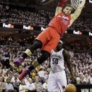 Los Angeles Clippers' Blake Griffin (32) hangs on the basket after dunking over Memphis Grizzlies' Zach Randolph (50) during the first half in Game 1 of a first-round NBA basketball playoff series, Sunday, April 29, 2012, in Memphis, Tenn. (AP Photo/Danny Johnston)