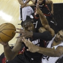 Miami Heat's Dwyane Wade (3) is defended by San Antonio Spurs' Tim Duncan, during the first half at Game 4 of the NBA Finals basketball series, Thursday, June 13, 2013, in San Antonio. (AP Photo/Derick E. Hingle, Pool)