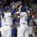 Los Angeles Dodgers' Yasiel Puig, second from right, greets teammates at home plate after hitting a grand slam home run in the eighth inning against the Atlanta Braves during a baseball game Thursday, June 6, 2013, in Los Angeles. The Dodgers won the game 5-0. (AP Photo/Alex Gallardo)