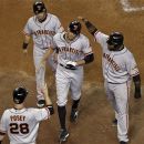 San Francisco Giants' Hunter Pence, center, is greeted by teammates Buster Posey (28), Marco Scutaro, top left, and Pablo Sandoval, right, after hitting a grand slam against the Arizona Diamondbacks during the third inning of a baseball game on Friday, Sept. 14, 2012, in Phoenix. (AP Photo/Matt York)