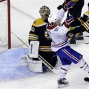 Boston Bruins goalie Tuukka Rask (40), of Finland, left, watches as the puck flies into the net while Boston Bruins defenseman Adam McQuaid (54), right, shoves Montreal Canadiens center David Desharnais (51), second from left, in the third period of an NHL hockey game at the TD Garden, in Boston, Sunday, March 3, 2013. The goal was scored by Canadiens left wing Max Pacioretty, not shown, to tie the game. The Canadiens beat the Bruins 4-3. (AP Photo/Steven Senne)
