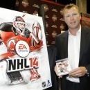 New Jersey Devils goalie Martin Brodeur poses for photographers with a copy of the NHL '14 video game, which dons an action shot of him on the cover, during a media availability before the start of the NHL hockey draft, Sunday, June 30, 2013, in Newark, N.J. (AP Photo/Julio Cortez)