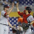 Washington Nationals relief pitcher Tyler Clippard, left, and catcher Kurt Suzuki celebrate after defeating the Miami Marlins 8-4 during a baseball game on Wednesday, Aug. 29, 2012, in Miami. (AP Photo/Wilfredo Lee)