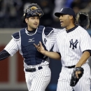 New York Yankees catcher Francisco Cervelli, left, puts his arm around Yankees relief pitcher Mariano Rivera after Rivera earned the save in their 4-2 victory over the Boston Red Sox in a baseball game at Yankee Stadium in New York, Thursday, April 4, 2013. (AP Photo/Kathy Willens)