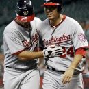 Washington Nationals' Gio Gonzalez, left, and Kurt Suzuki (24) head for the dugout after Gonzalez hit a two-run home run against the Houston Astros in the second inning of a baseball game, Wednesday, Aug. 8, 2012, in Houston. (AP Photo/Pat Sullivan)