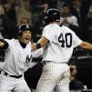 New York Yankees' Ichiro Suzuki, left, of Japan, celebrates with Francisco Cervelli (40) after Cervelli scored on an RBI single from Raul Ibanez during the 12th inning of a baseball game, Tuesday, Oct. 2, 2012, in New York. The Yankees won 4-3. (AP Photo/Frank Franklin II)