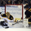 Boston Bruins' goaltender Anton Khudobin (35), of Kazakhstan, makes a save on Buffalo Sabres' left winger Nathan Gerbe (42) during the first period of an NHL hockey game in Buffalo, N.Y., Sunday, Feb. 10, 2013. (AP Photo/Gary Wiepert)