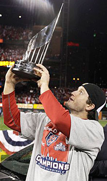 David Freese holds up the MVP trophy.