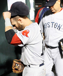 Dustin Pedroia walks into the locker room after a 4-3 loss against the Orioles.