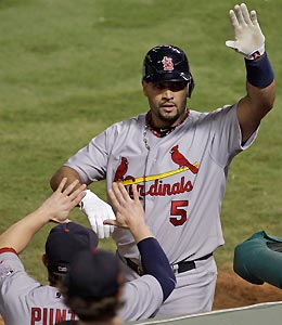 The Cardinals' Albert Pujols celebrates after hitting a two-run home run during the seventh inning of Game 3 of the World Series against the Rangers.