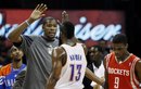 Oklahoma City Thunder forward Kevin Durant , left, high-fives teammate James Harden (13) during a time-out in the fourth quarter of an NBA basketball game against the Houston Rockets in Oklahoma City, Friday, Jan. 6, 2012. Houston guard Jonny Flynn , right, walks offcourt. Oklahoma City won 109-94.