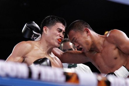 Indonesia's Daud Jordan Blows A Punch To Opponant Lorenzo Villanueva Of Philippines To Win The IBO Vacant World