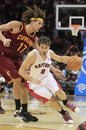 Toronto Raptors ' Jose Calderon (8) drives past Cleveland Cavaliers ' Anderson Varejao (17), from Brazil, in the fourth quarter in an NBA basketball game Monday, Dec. 26, 2011, in Cleveland. Calderon scored 15 points for the Raptors 104-96 win.