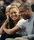 Entertainer Jay-Z reacts with his wife, Beyonce, left, during the third quarter of an NBA basketball game between the New York Knicks and New Jersey Nets , Monday, Feb. 20, 2012, at Madison Square Garden in New York.