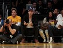 Ashton Kutcher, center, reacts  during the second half of an NBA basketball game between the Los Angeles Lakers and the Memphis Grizzlies , Sunday, March 25, 2012, in Los Angeles. The Grizzlies won 102-96.