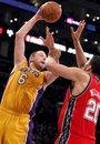 Los Angeles Lakers forward Josh McRoberts (6) shoots over New Jersey Nets forward Jordan Williams (20) during the second half of an NBA basketball game in Los Angeles, Tuesday, April 3, 2012. The Lakers won the game 91-87.