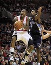 Portland Trail Blazers guard Jamal Crawford , left, flies to the hoop past Memphis Grizzlies guard Tony Allen during the second half of their NBA basketball game in Portland, Ore., Tuesday, Jan. 24, 2012.  Crawford came off the bench to score 15 points in the Blazers 97-84 win over the Grizzlies.