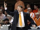 Oklahoma State coach Travis Ford signals to his team during the first half of an NCAA college basketball game against Kansas in Stillwater, Okla., Monday, Feb. 27, 2012. Kansas won 70-58.