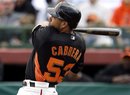 San Francisco Giants ' Melky Cabrera drives in a one-run double against the Colorado Rockies during the third inning of a spring training baseball game Wednesday, March 7, 2012, in Scottsdale, Ariz.