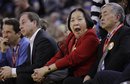 Oakland Mayor Quan, center, yawns beside her husband, Dr, Floyd Huen, right, and Golden State Warriors majority owner Joe Lacob during the second half of an NBA basketball game against the Oklahoma City Thunder Friday, Jan. 27, 2012, in Oakland, Calif.