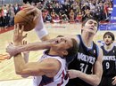 Minnesota Timberwolves center Darko Milicic , center, of Serbia fouls Los Angeles Clippers forward Blake Griffin , left, as guard Ricky Rubio of Spain looks on during the second half of their NBA basketball game, Friday, Jan. 20, 2012, in Los Angeles. The Timberwolves won 101-98.