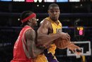 Los Angeles Lakers ' Andrew Bynum , right, is pressured by Houston Rockets ' Jordan Hill during the first half of an NBA basketball game in Los Angeles,  Tuesday, Jan. 3, 2012.