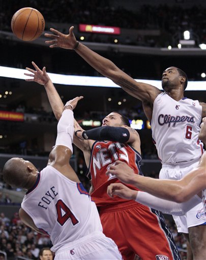 New Jersey Nets Guard Jordan Farmar, Center, Goes For A Layup Defended By Los Angeles Clippers DeAndre Jordan (6) And