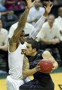 Long Beach State forward Eugene Phelps, left, blocks the path of Kansas State guard Angel Rodriguez (13) in the first half of an NCAA college basketball game on Sunday, Dec. 25, 2011, in Honolulu.