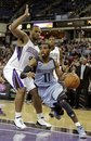 Memphis Grizzlies guard Mike Conley , right,drives the baseline against Sacramento Kings forward Chuck Hayes during the second half of an NBA basketball game in Sacramento, Calif., Tuesday, March  20, 2012.  The Kings won 119-110.